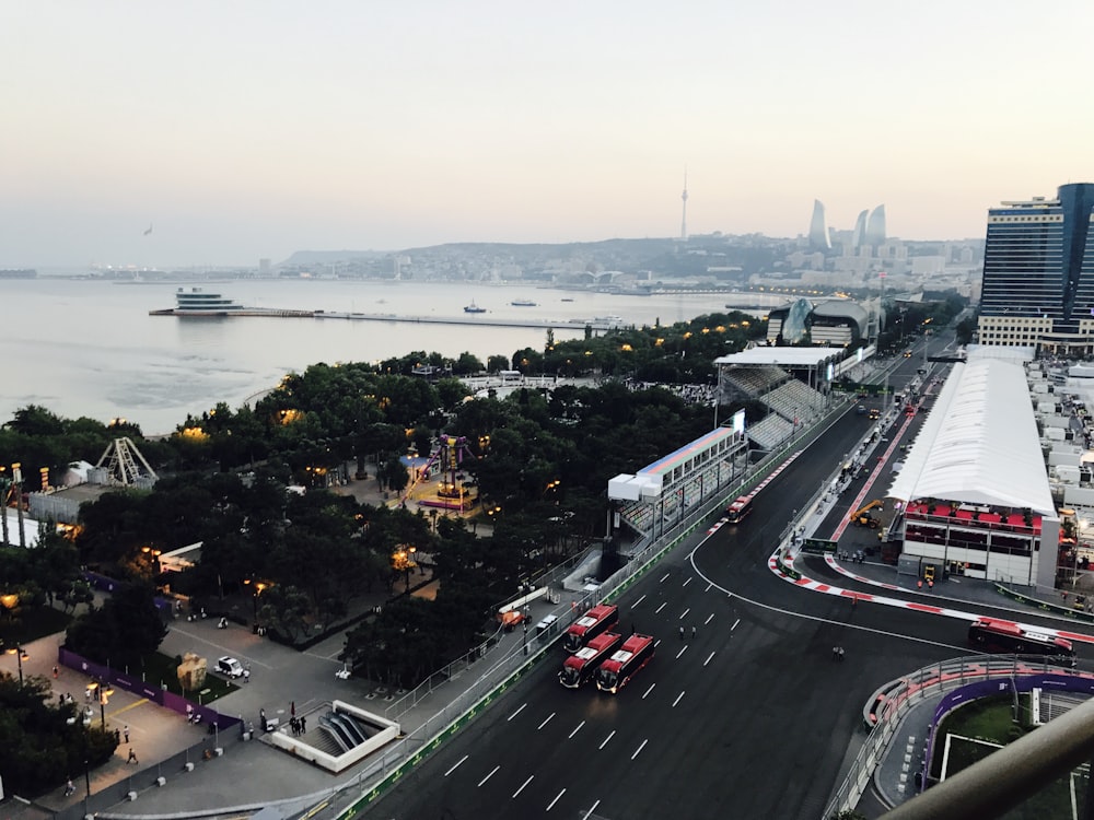 cars on road near body of water during daytime