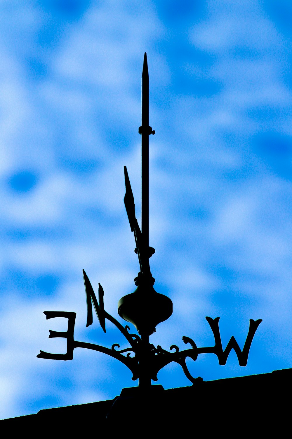 black metal lamp post under blue sky
