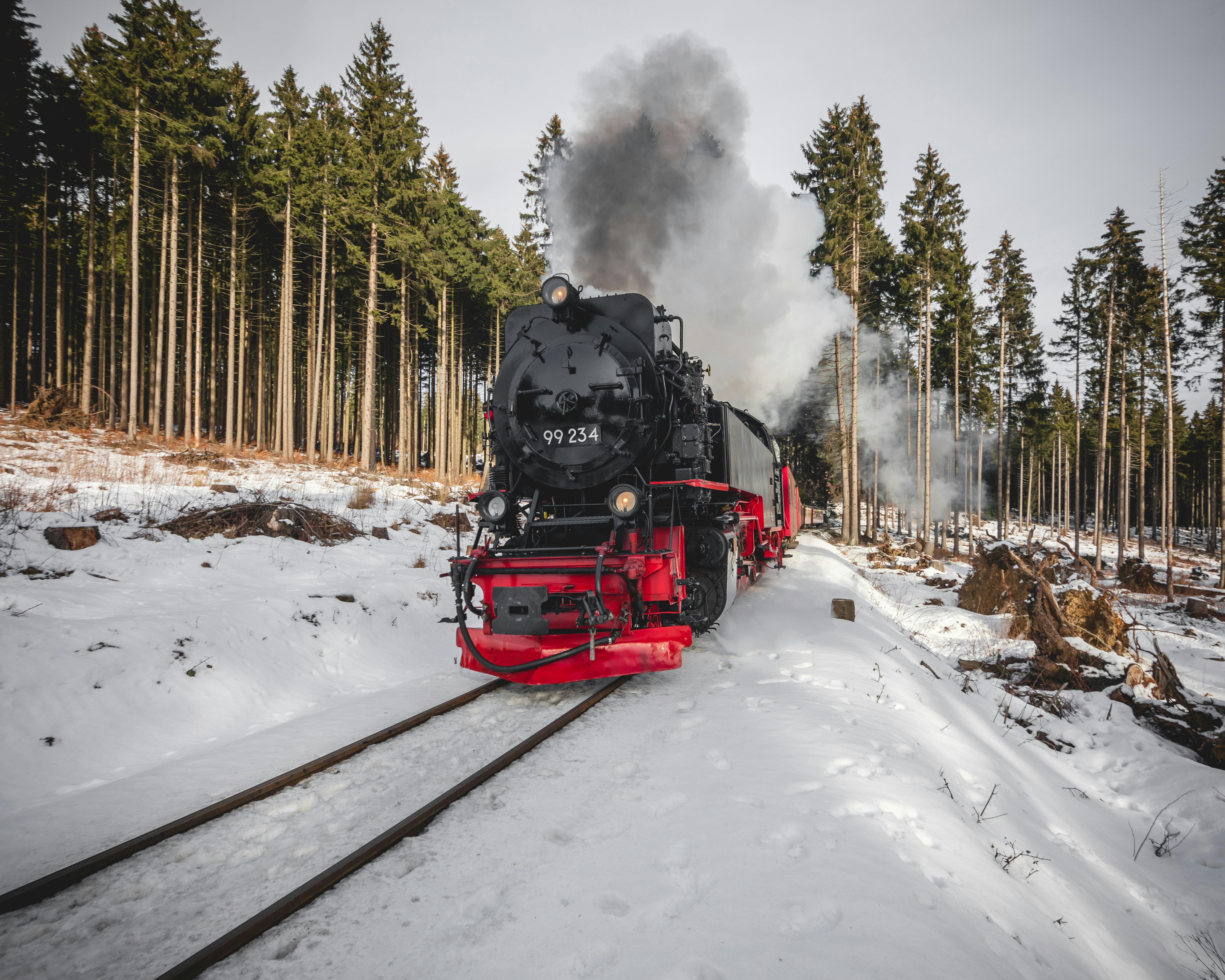red and black train on snow covered ground during daytime, Brockenbahn.
