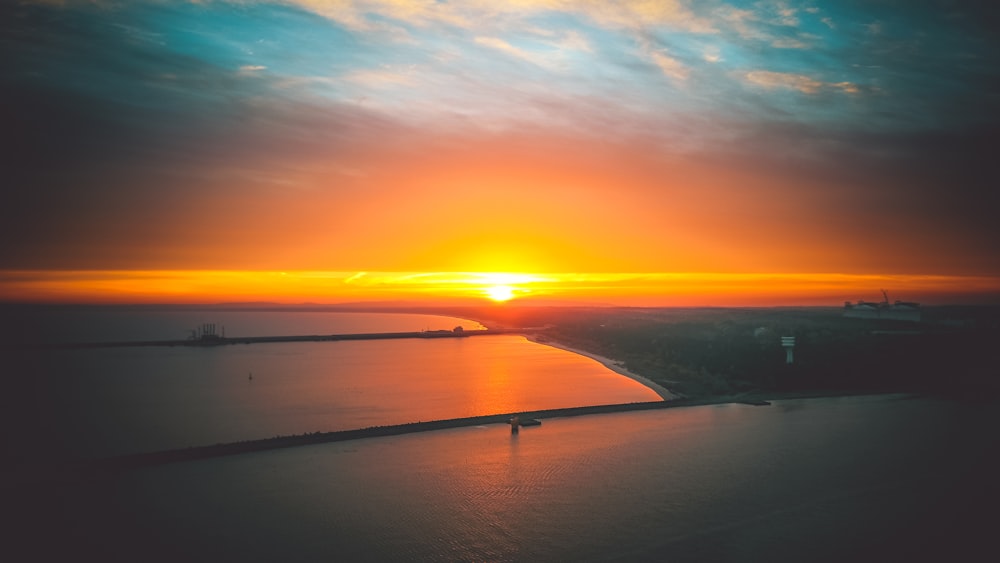 body of water during sunset