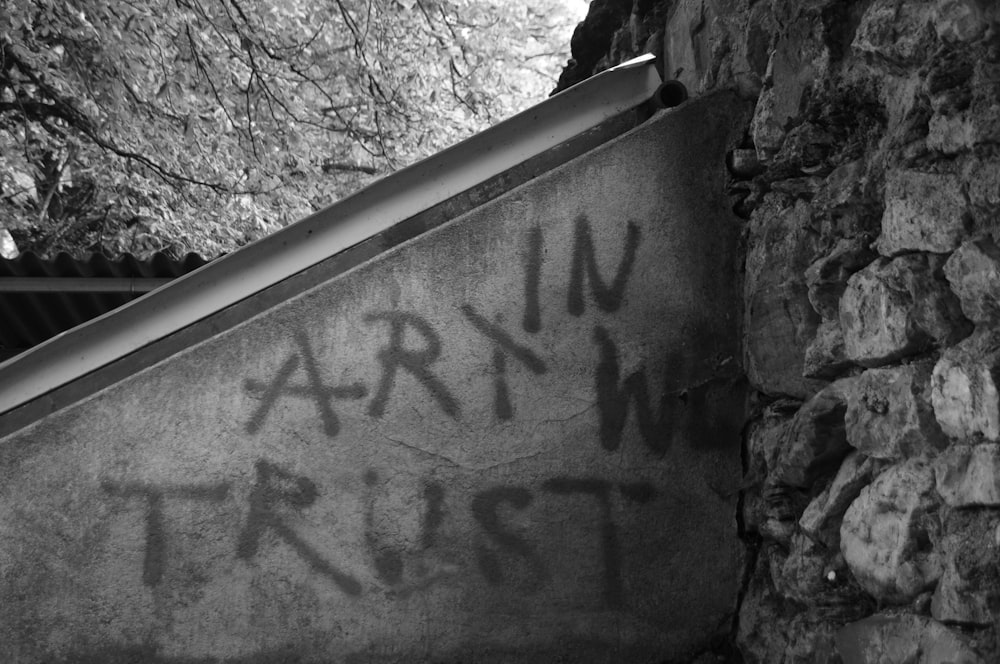 a black and white photo of graffiti on a wall