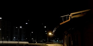 Nighttime photo of a lit-up roof repair job, highlighting 24/7 service dedication.