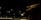 Nighttime scene of roofing contractors working under bright lights on a commercial building roof.