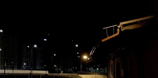 Nighttime photo of a lit-up roof repair job, highlighting 24/7 service dedication.