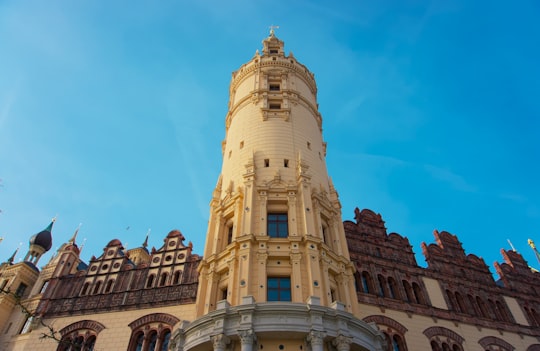 brown concrete building under blue sky during daytime in Schwerin Castle Germany
