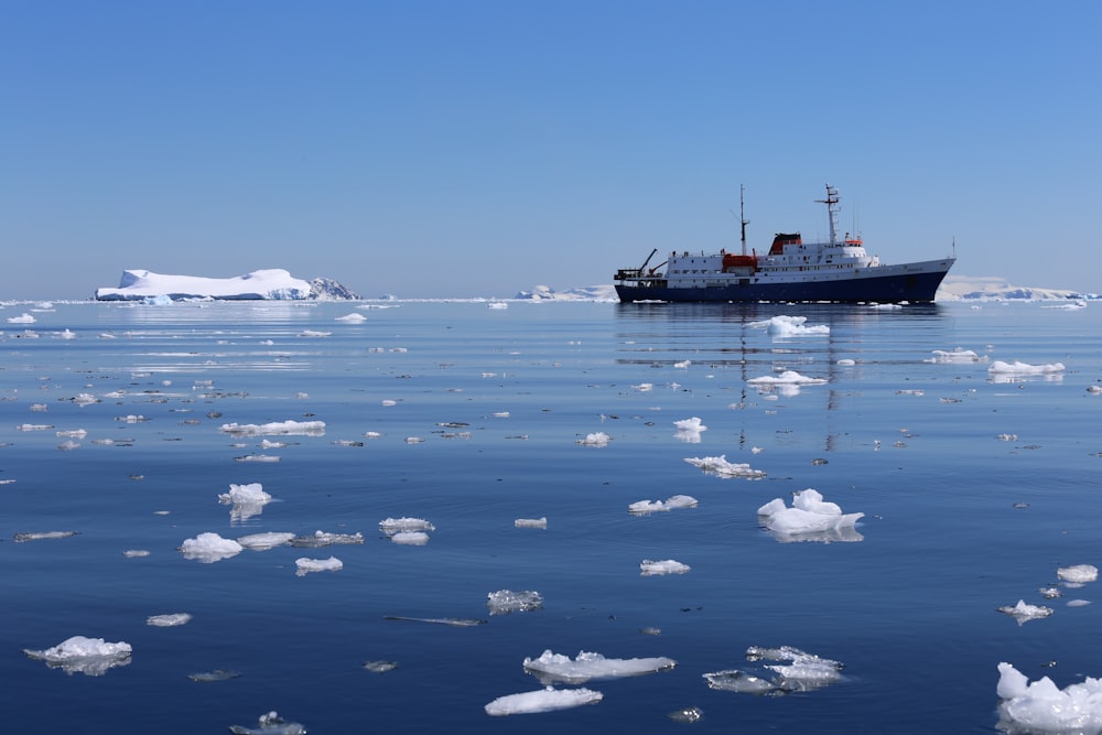 black ship on sea under blue sky during daytime