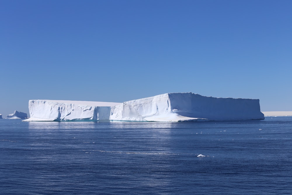 white and gray rock formation on sea under blue sky during daytime