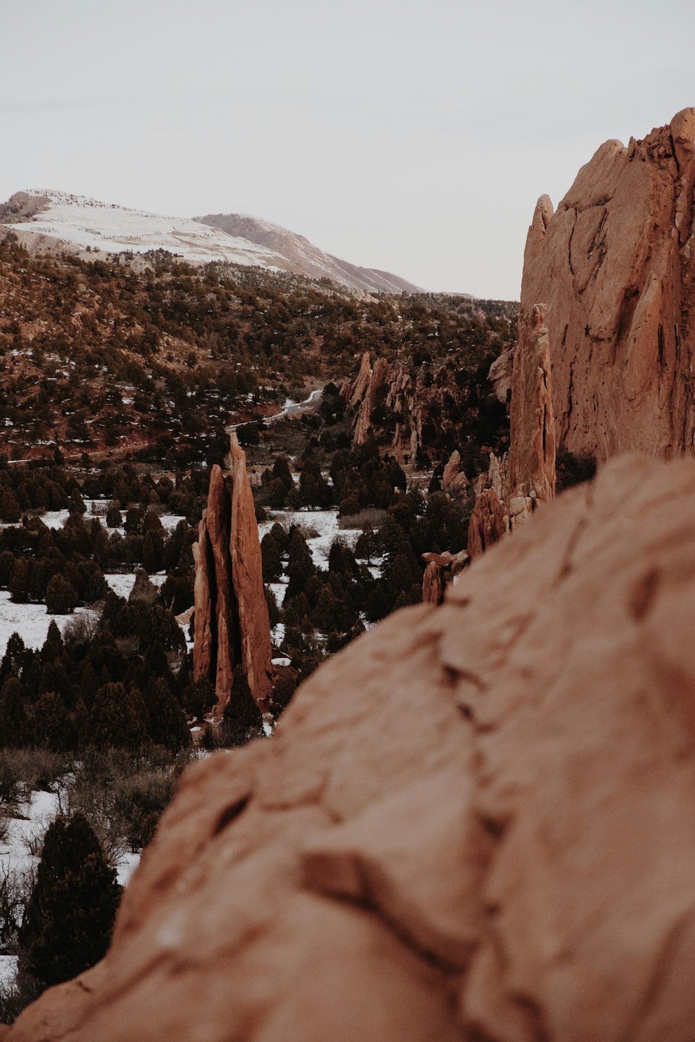 brown rock formation covered with snow during daytime