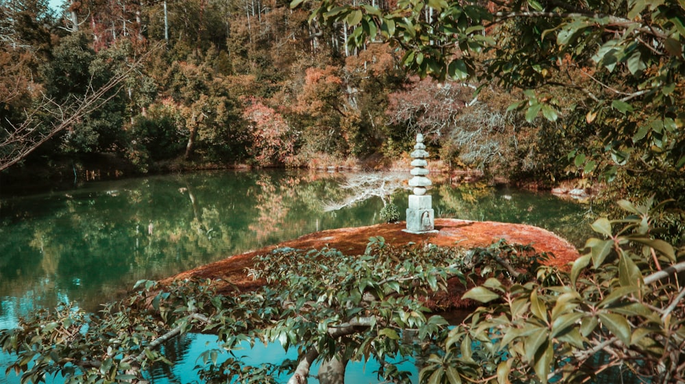 white and brown lighthouse near body of water