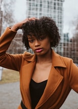 woman in brown blazer and black shirt