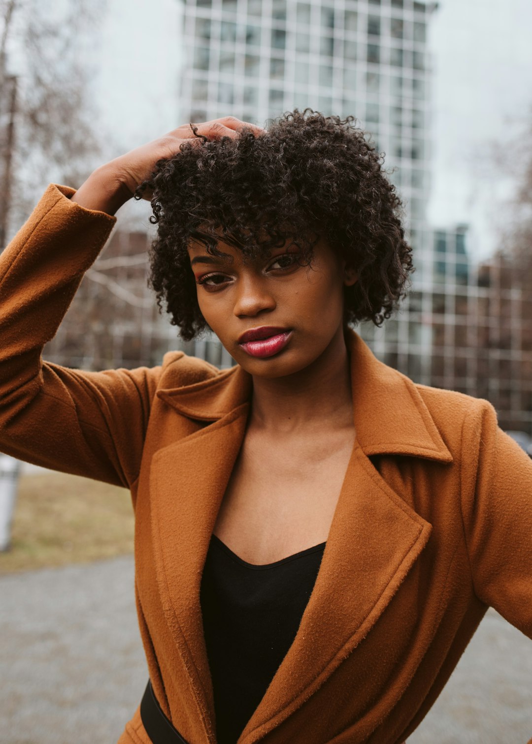 woman in brown blazer and black shirt