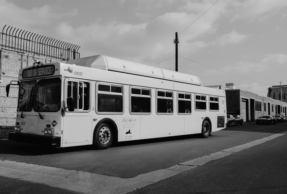 grayscale photo of bus on road