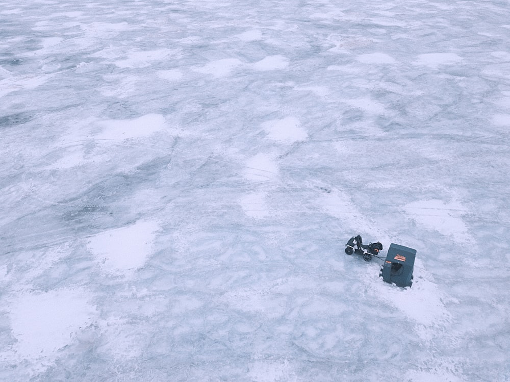 black and red plastic toy on snow covered ground