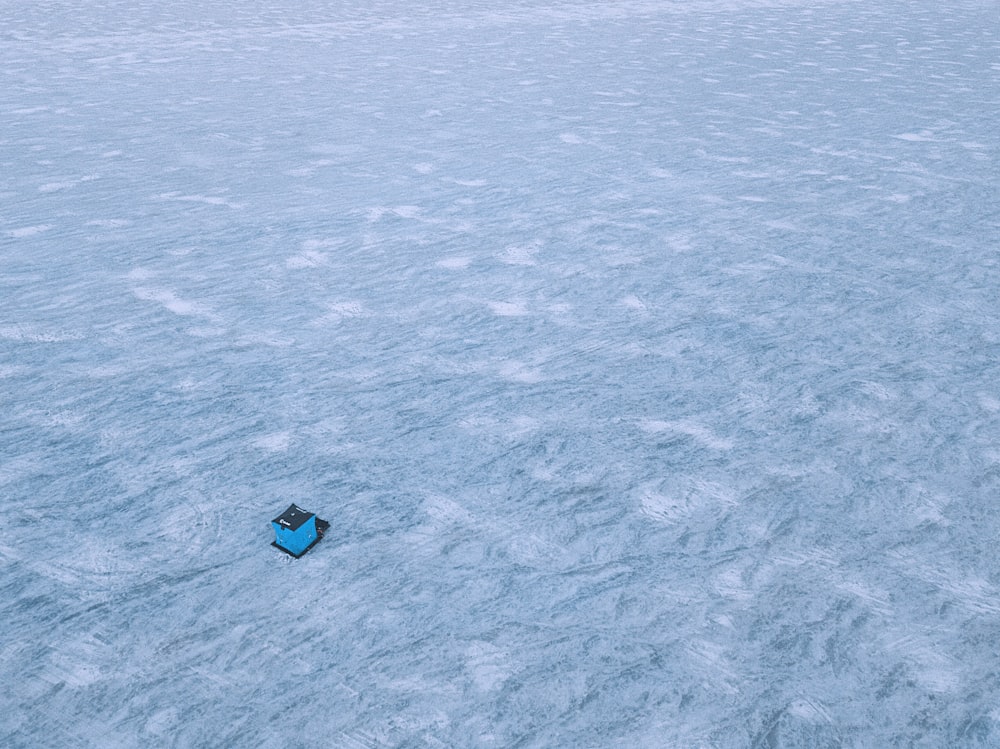 blue boat on body of water during daytime