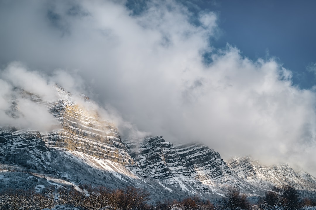 snow covered mountain under cloudy sky during daytime