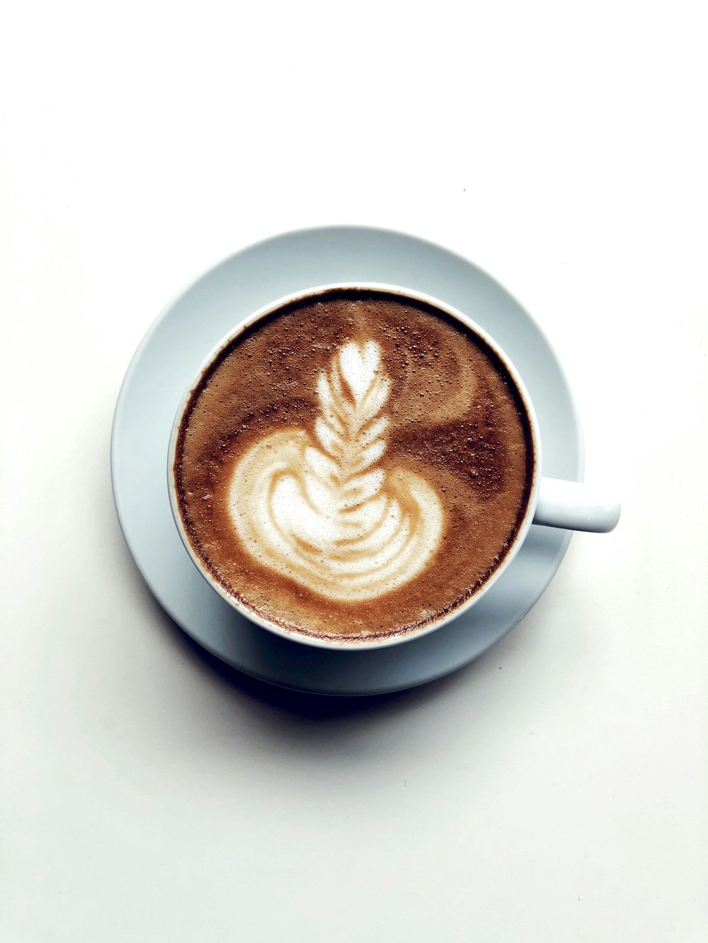 white ceramic mug with brown liquid