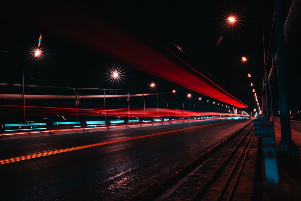 red light on bridge during night time