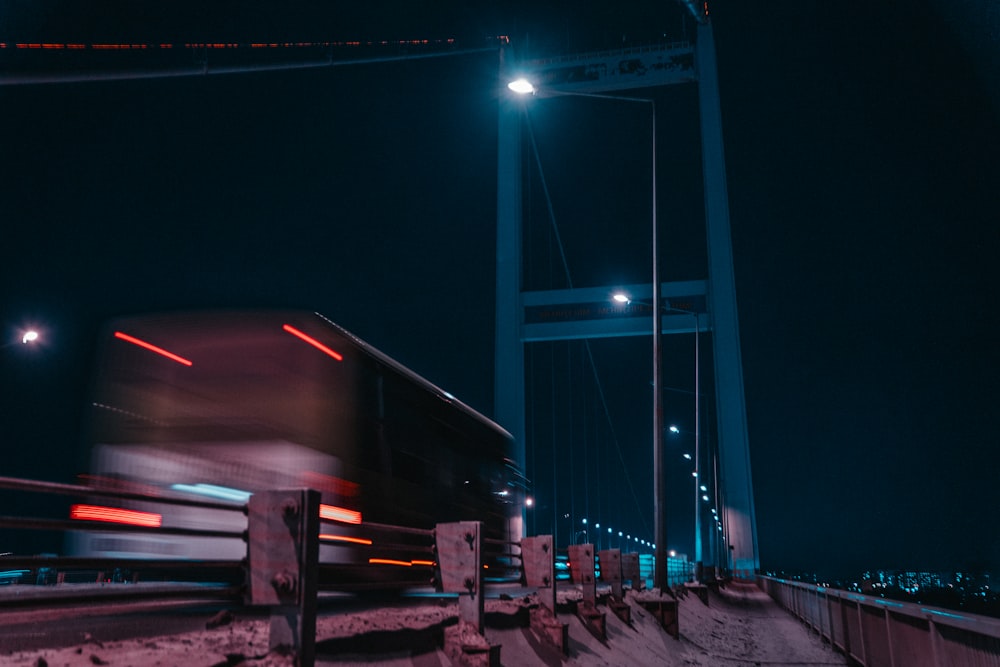 gray bridge under blue sky during night time