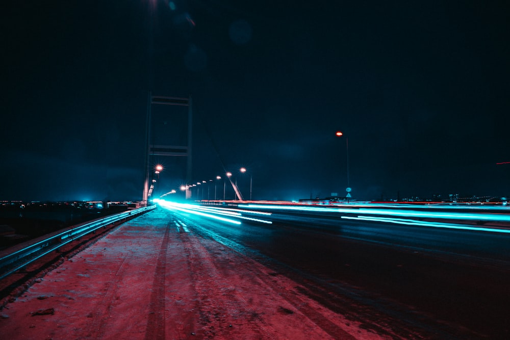 blue and white light streaks of cars on road during night time