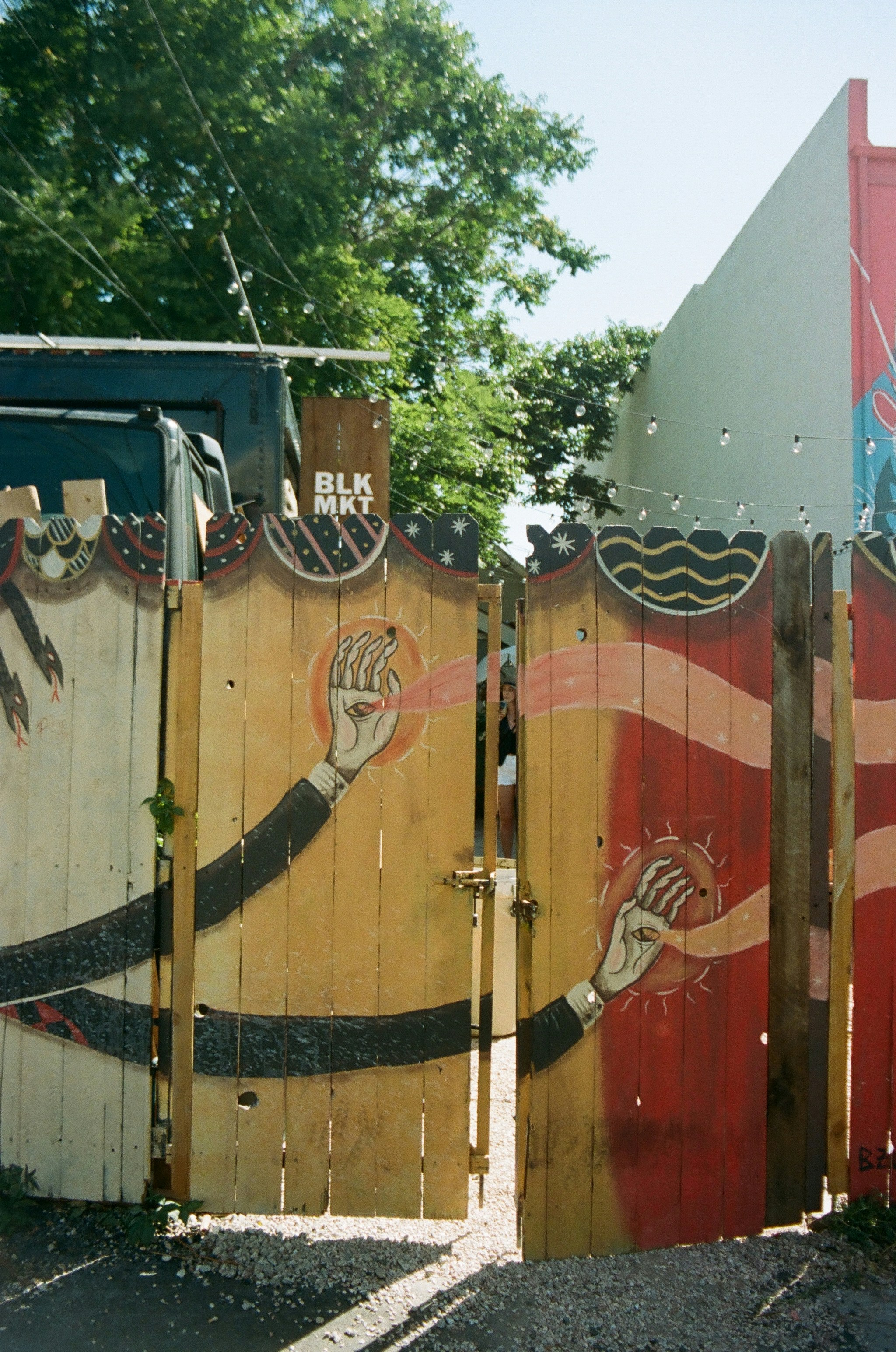 black and white flag on brown wooden fence