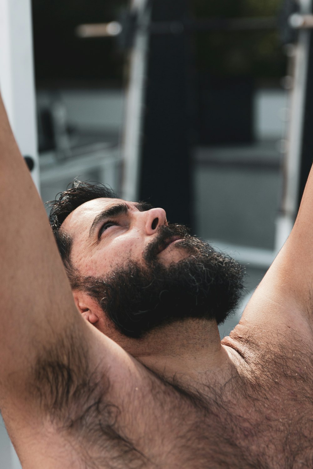 man with black hair lying on floor