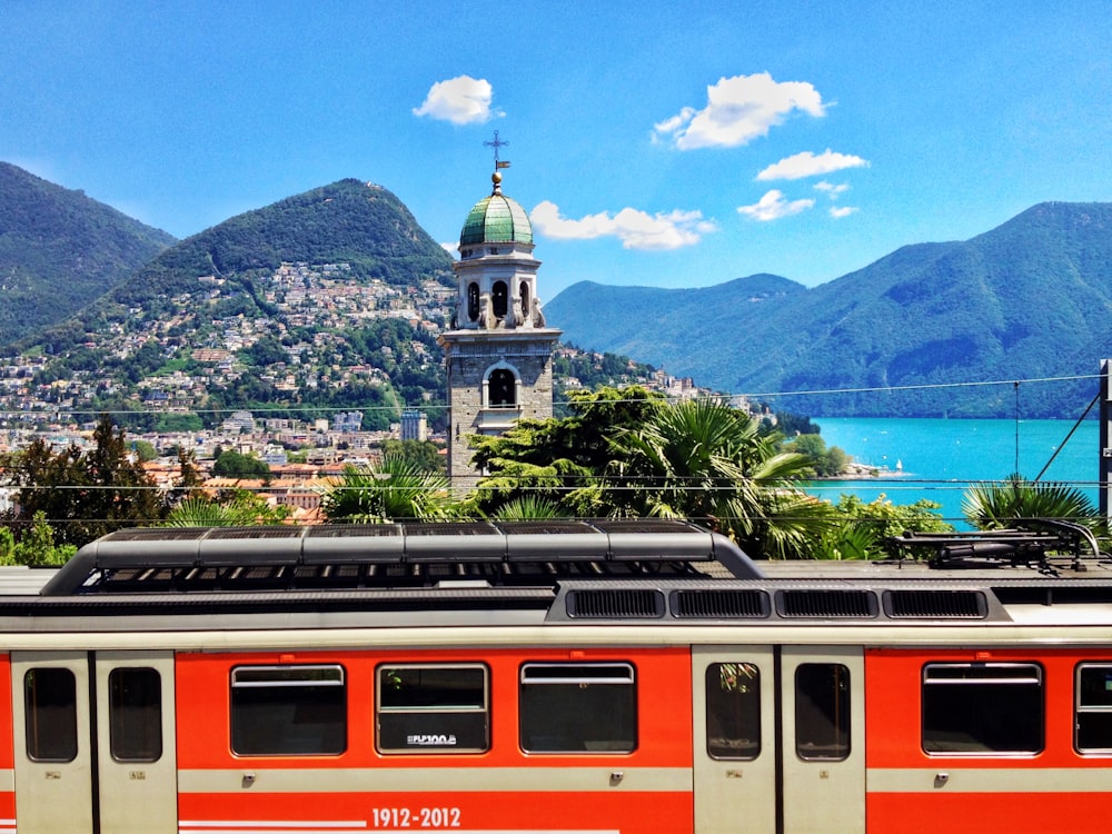 white and red train on rail during daytime