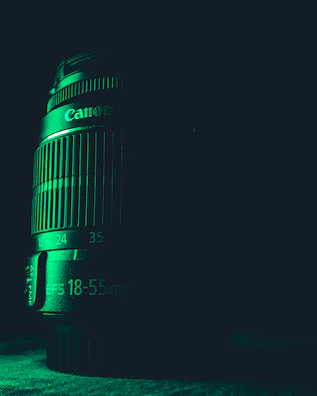 Close-up of a camera lens focusing on a dramatic scene under natural light.