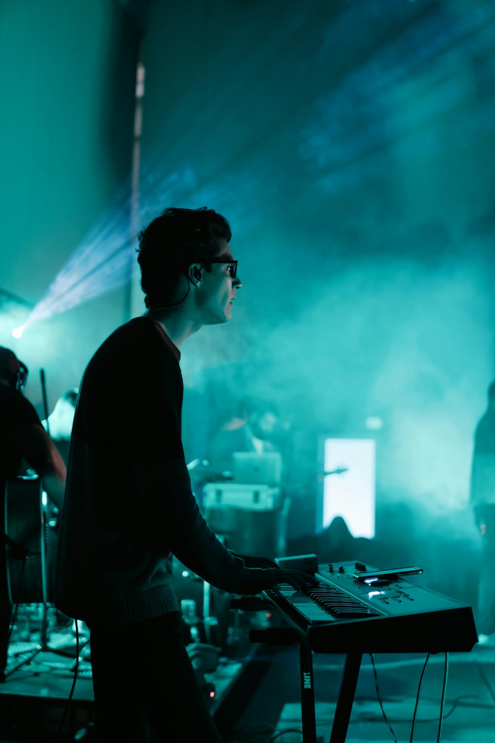 man in black long sleeve shirt playing piano