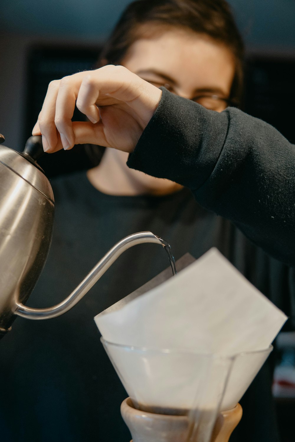 person holding stainless steel kettle