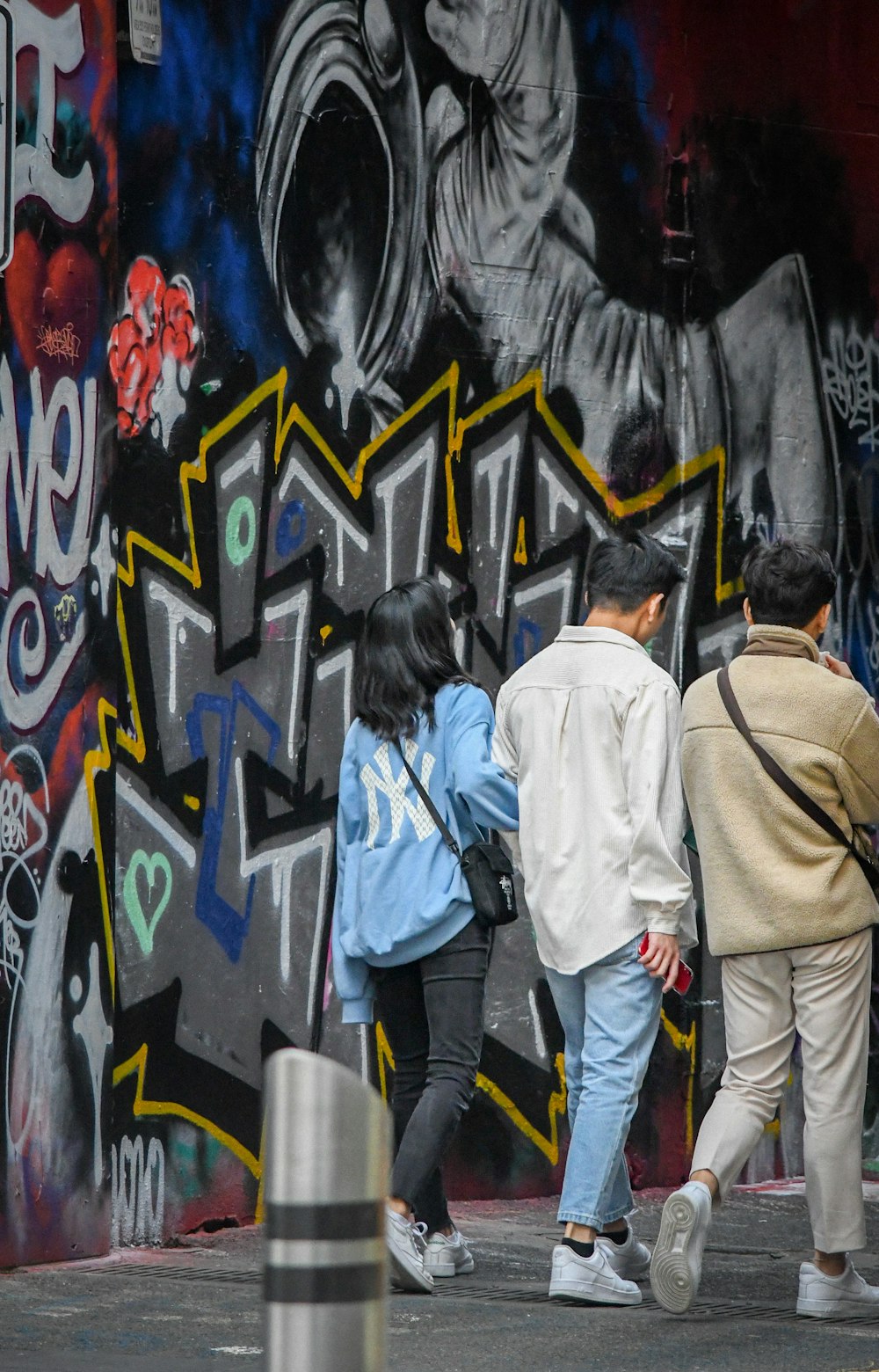 man in brown jacket standing beside woman in blue jacket