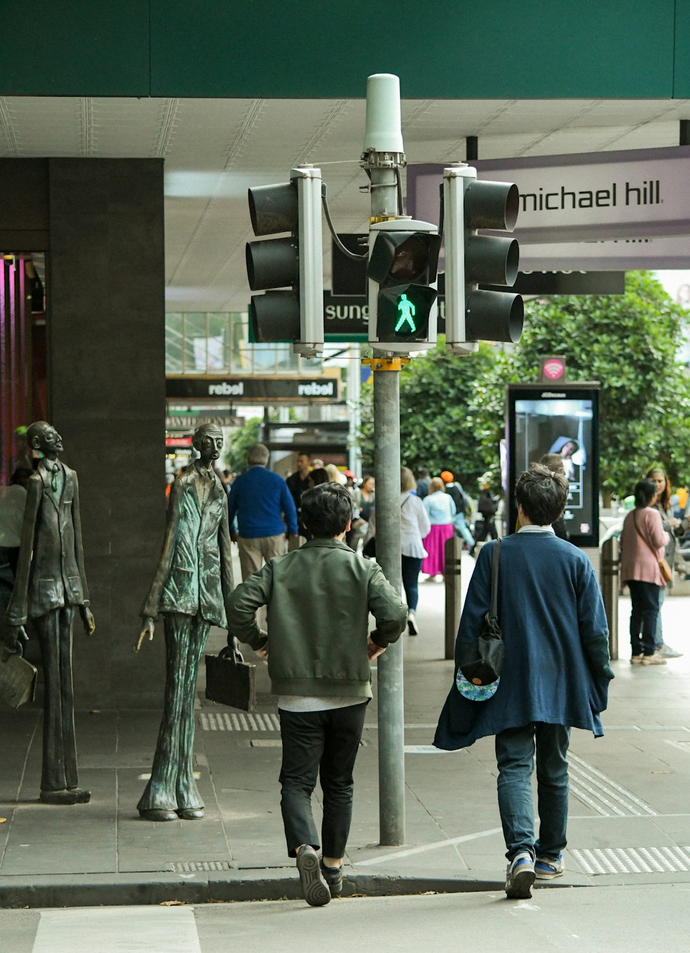 people walking on sidewalk during daytime