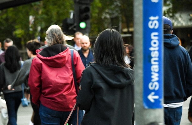 A group of tourists exploring a vibrant Melbourne street.