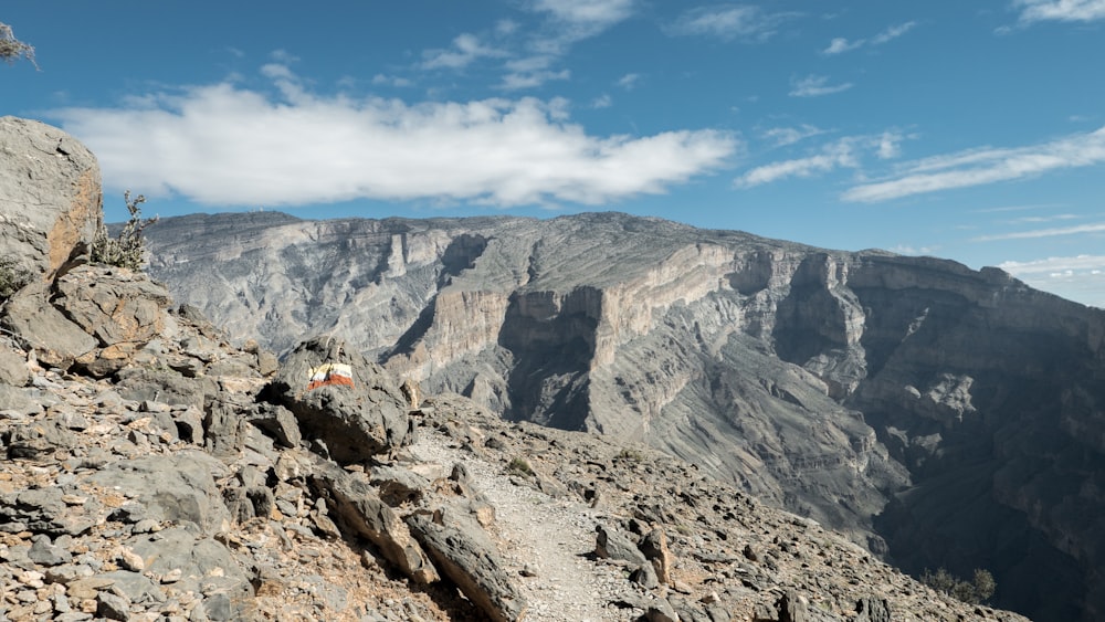 person sitting on rock mountain during daytime