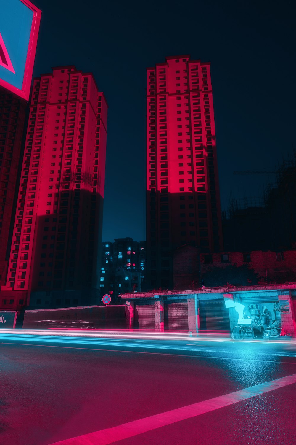 red and white city building during night time