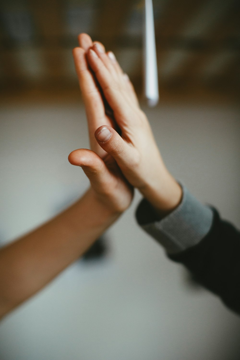 person in black long sleeve shirt holding hand of person in black long sleeve shirt