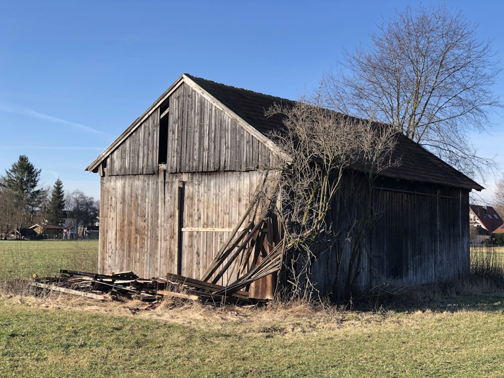 brown wooden barn under blue sky during daytime