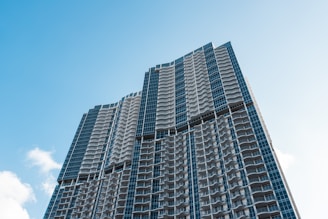 Modern residential tower in Monterrey with clear blue sky background.