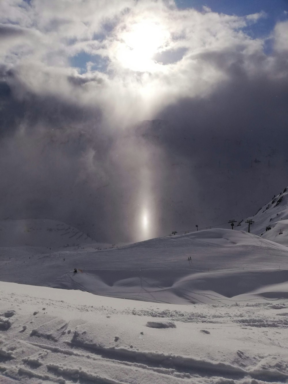 snow covered mountain under white clouds during daytime