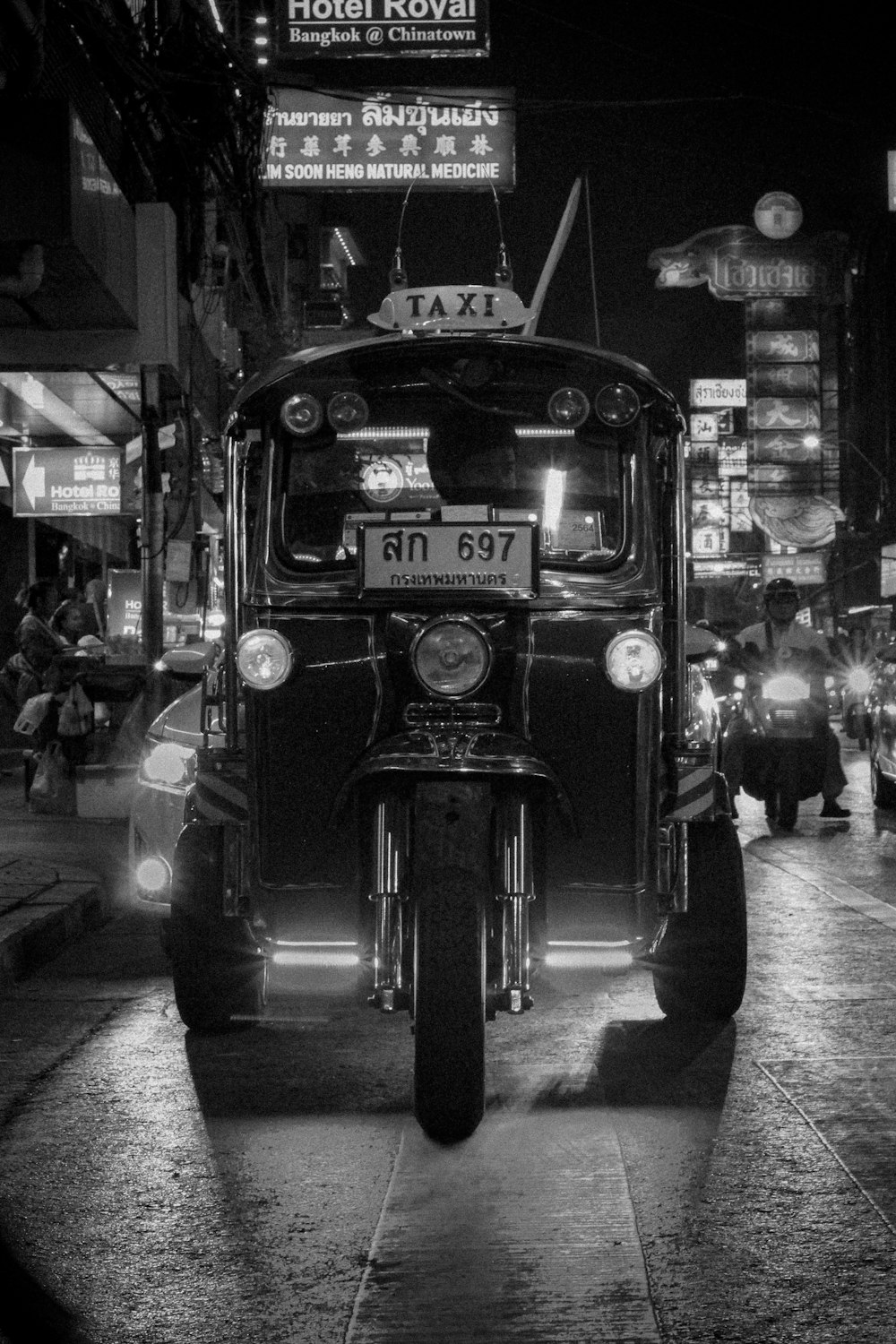 grayscale photo of man riding motorcycle