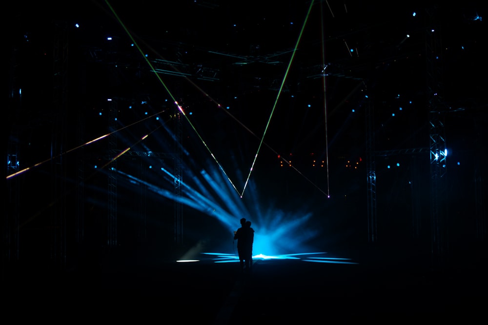man standing on stage with lights