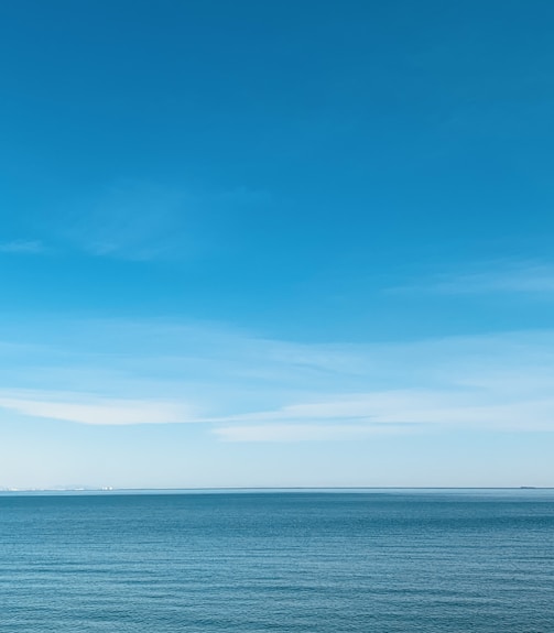 blue sea under blue sky during daytime