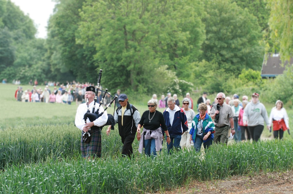 people standing on green grass field during daytime