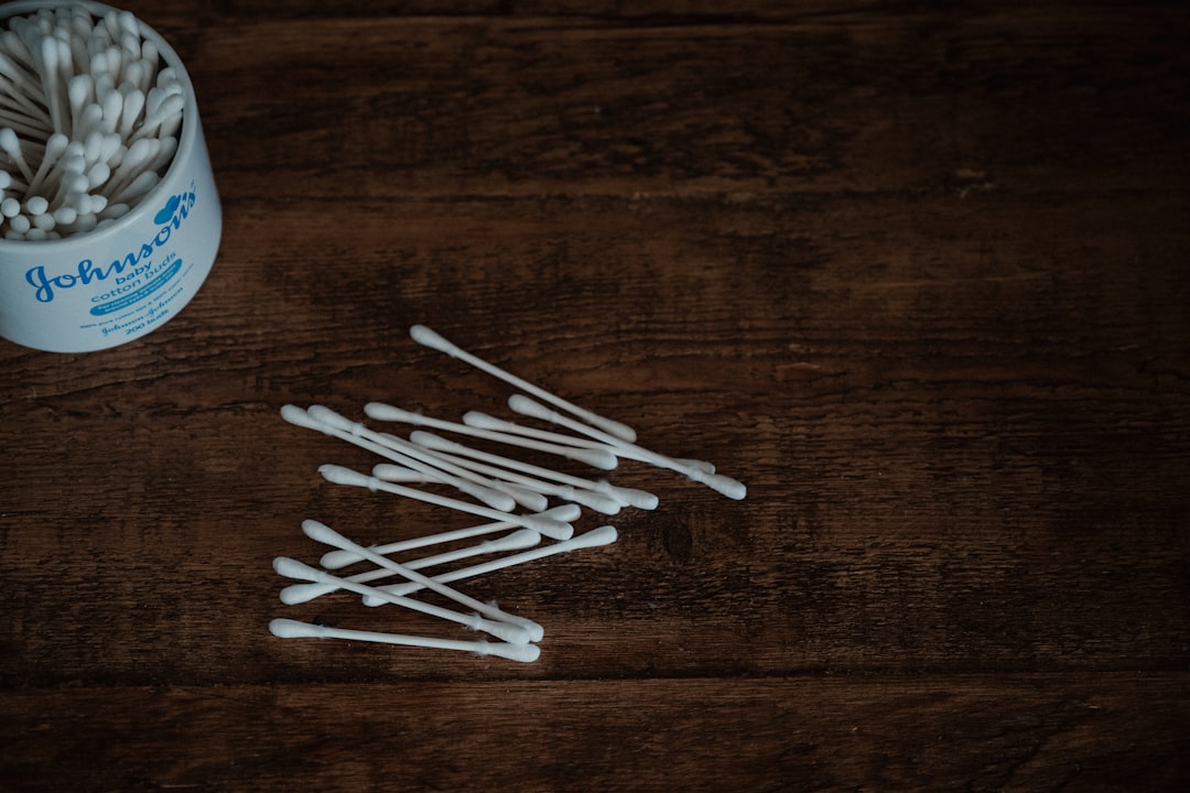 white cotton buds on brown wooden table