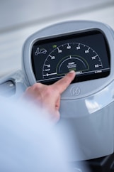 person holding car instrument panel cluster