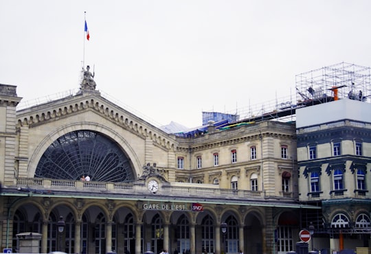 beige concrete building under white sky during daytime in Gare de l'Est France