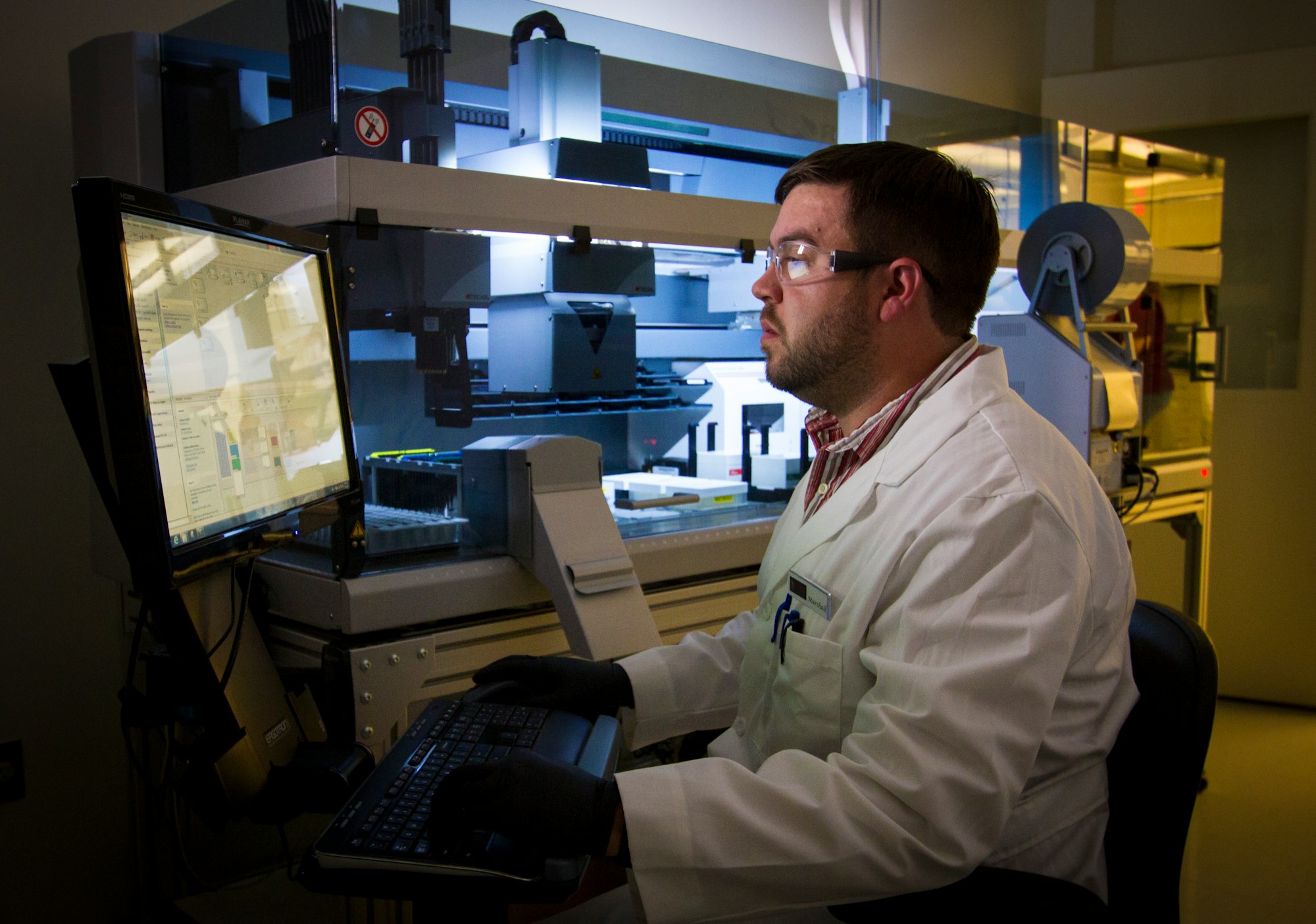 DNA Genotyping and Sequencing. A technician reviews data from high-throughput DNA genotyping and sequencing at the Cancer Genomics Research Laboratory, part of the National Cancer Institute's Division of Cancer Epidemiology and Genetics (DCEG).