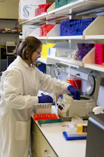 Medical technician working with laboratory equipment in a bright, modern lab