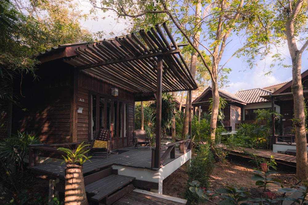 brown wooden house near green trees during daytime