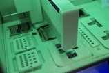 white and teal printer on white desk