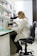 woman in white robe sitting on black office rolling chair